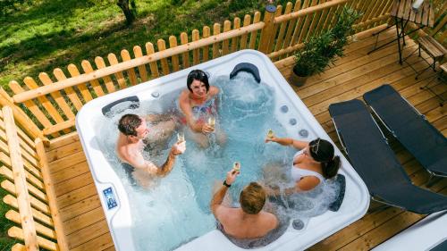 a group of people playing in a hot tub at Connyhaus St Oswald ob Eibiswald in Sankt Oswald ob Eibiswald