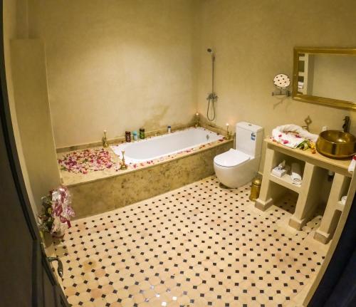 a toy bathroom with a tub and a toilet at kasbah yu palace in Ouarzazate