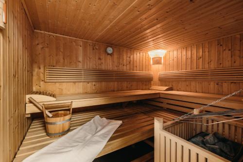 a wooden sauna with a bench and a table at Chalet Lenzi in Sankt Anton am Arlberg