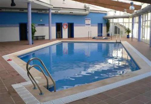a large swimming pool in a building at Lovely Apartment in Vera Playa in Playas de Vera
