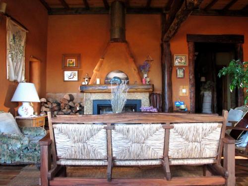 a living room with a couch and a fireplace at Casal da Serra in Penha Garcia
