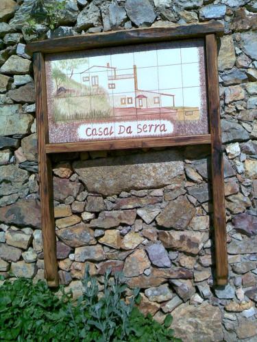 a sign on the side of a stone wall at Casal da Serra in Penha Garcia