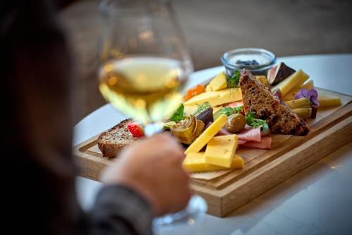 a plate of cheese and bread and a glass of wine at Crowne Plaza - Warsaw - The HUB by IHG in Warsaw