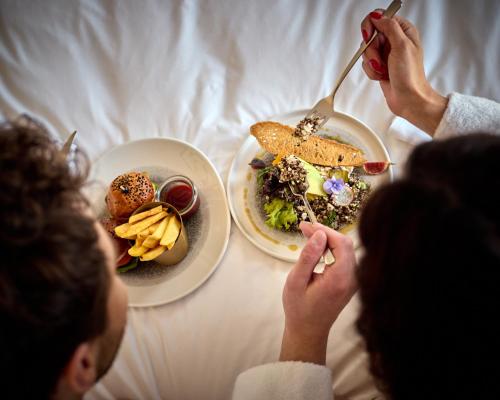 a group of people sitting at a table with plates of food at Crowne Plaza - Warsaw - The HUB by IHG in Warsaw