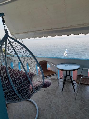 a hammock on a cruise ship looking out at the ocean at Delfini in Akhladherí