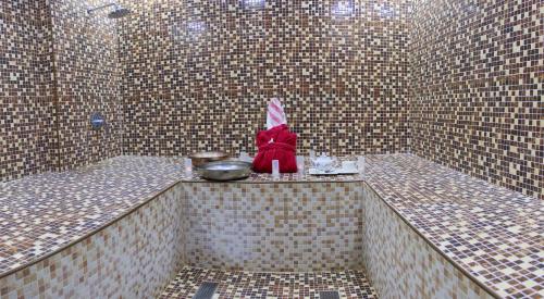 a small bathroom with a rabbit sitting on a counter at Hyatt Place Dubai Jumeirah in Dubai