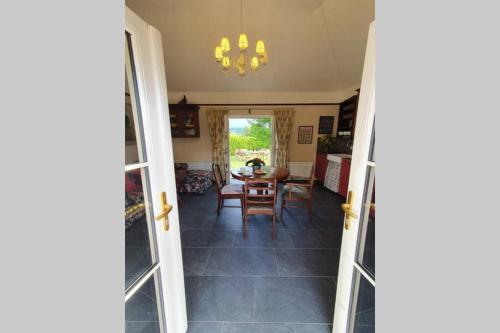 a room with a table and a dining room at Yellow Heights Accommodation in Tinahely