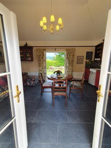 a dining room with a table and chairs at Yellow Heights Accommodation in Tinahely