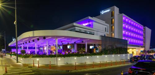 ein Gebäude mit lila Lichtern davor in der Unterkunft Seasons Hotel (Adults Only) in Ayia Napa