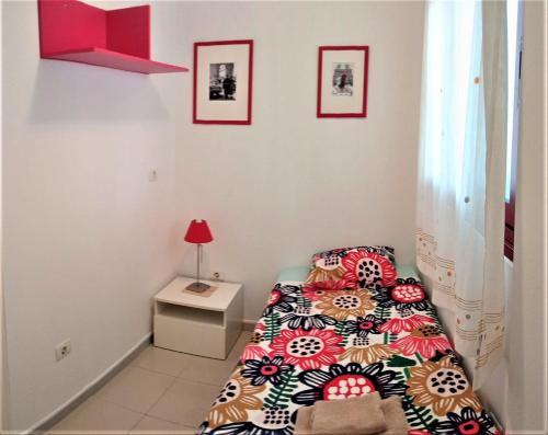 a small bedroom with a bed and a table at Beautiful Apartment in Palm-Mar