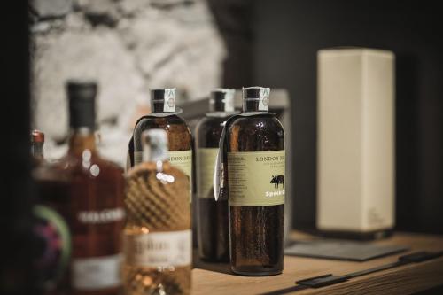 a group of bottles of alcohol sitting on a table at Autentis in Rasùn di Sotto