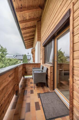a balcony with a chair and a large window at Haus Rabl in Itter