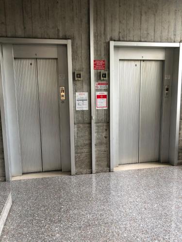 three elevators in a building with three doors at NANNARE' APPARTAMENT in Reggio Emilia