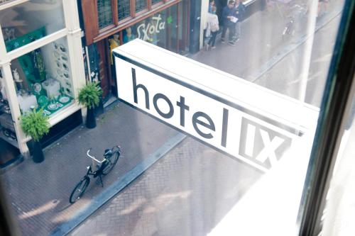 a bike parked in front of a hotel sign at Hotel IX Nine Streets Amsterdam in Amsterdam