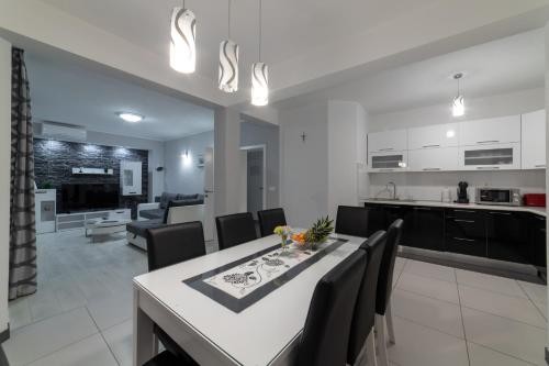 a kitchen and living room with a table and chairs at Villa Ban in Trogir