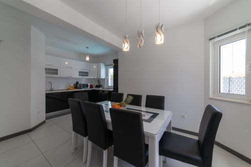 a kitchen and dining room with a table and chairs at Villa Ban in Trogir