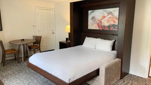 a bedroom with a large bed and a table at Club Wyndham Branson at The Falls in Branson