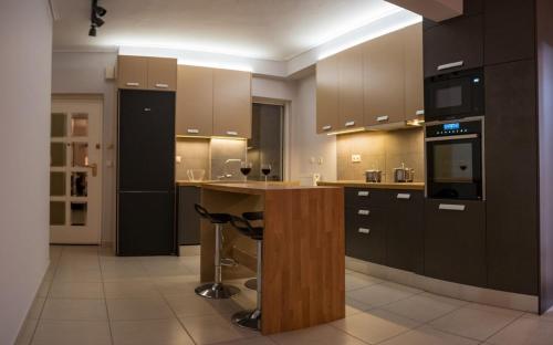a large kitchen with a island in the middle at It is a pleasant, modern, functional house! in Piraeus