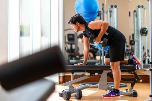 a man in a gym working out on a treadmill at Crowne Plaza Muscat OCEC by IHG in Muscat
