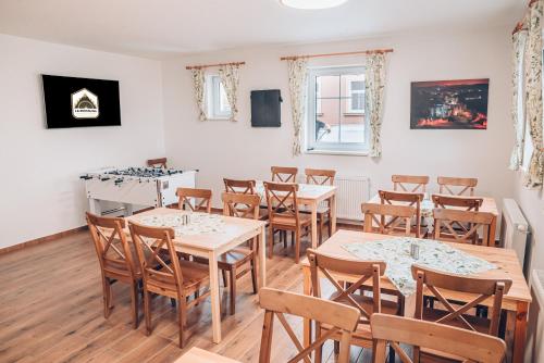 a dining room with wooden tables and chairs at Penzion La Piccolina in Nový Bor