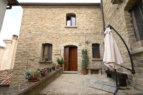 a building with an umbrella in front of it at Petra Holiday Home in Pietrapertosa