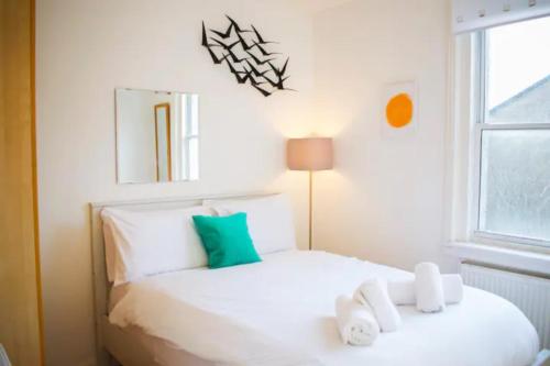 a bedroom with a white bed and a window at GuestReady - Calm and Central sleeps up to 6 in Edinburgh