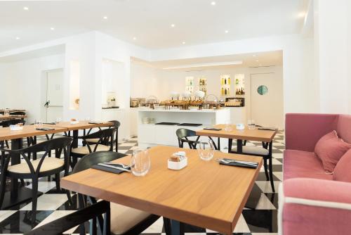 a restaurant with tables and chairs and a fireplace at Hotel Morfeo in Milan