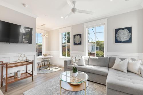 a living room with a couch and a table at The Jasmine Suite at 124 Spring in Charleston