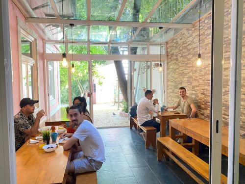 a group of people sitting at tables in a restaurant at Safestay Lisbon Bairro Alto in Lisbon