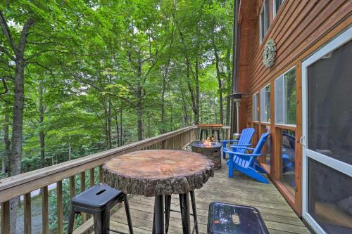 a deck with a table and chairs on a house at Private Hot Tub Cabin 1 Mi to Beech Mountain! in Beech Mountain