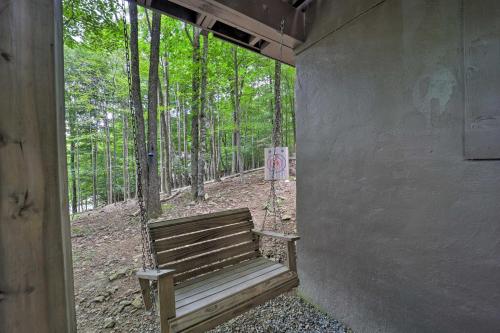 a wooden bench sitting in the middle of a forest at Private Hot Tub Cabin 1 Mi to Beech Mountain! in Beech Mountain