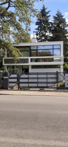 a building with a fence in front of a street at Magnifique appartement- Brussels expo Laeken in Brussels