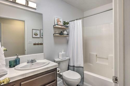 a bathroom with a sink and a toilet and a shower at Stylish Bakersfield Getaway with Pool Table! in Bakersfield