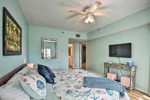 a bedroom with a bed and a flat screen tv at Walk to Ocean Condo with Pool in New Smyrna Beach in New Smyrna Beach