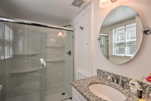 a bathroom with a shower and a sink and a mirror at Cozy Athens Cottage Walk to Sanford Stadium! in Athens