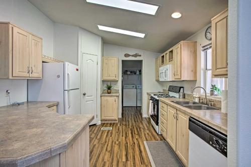a kitchen with white appliances and wooden cabinets at Sedona Home with View, Half-Mi to Chimney Rock! in Sedona