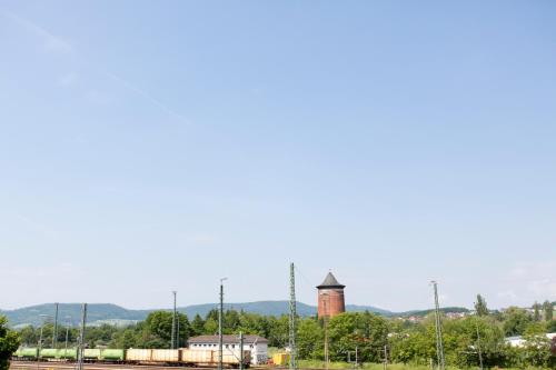 a train yard with a tower in the distance at Stadthotel Lichtenfels in Lichtenfels