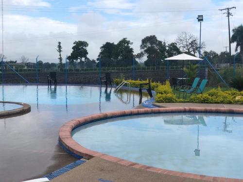 a swimming pool in a park with water in it at VACACIONES a 3 km del Parque del Cafe in Montenegro