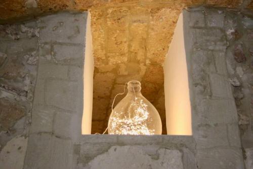a glass vase sitting inside of a stone window at Gesuiti 25 in Bari