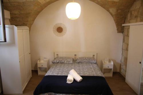 a bedroom with a bed with two towels on it at Gesuiti 25 in Bari