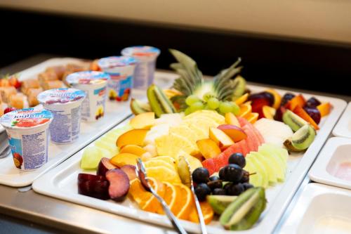 two trays filled with different types of fruits and vegetables at Stadthotel Lichtenfels in Lichtenfels