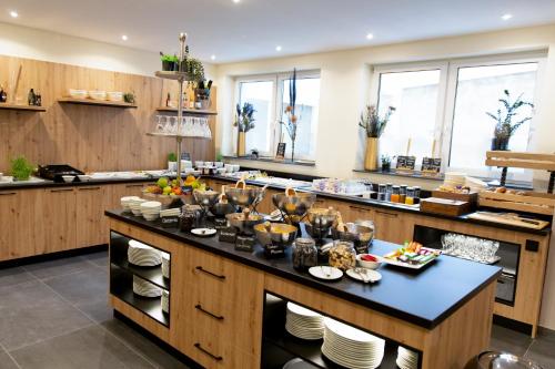 a kitchen with a large island with dishes on it at Stadthotel Lichtenfels in Lichtenfels