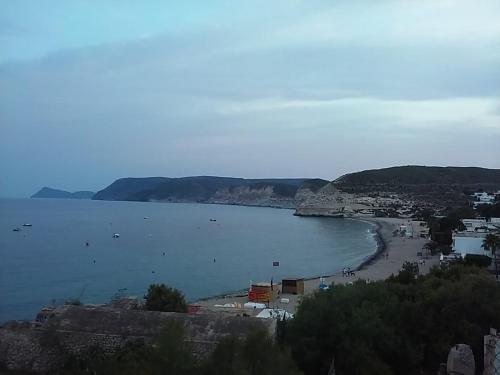 a view of a beach with a town and the ocean at Arto Blanco in Agua Amarga
