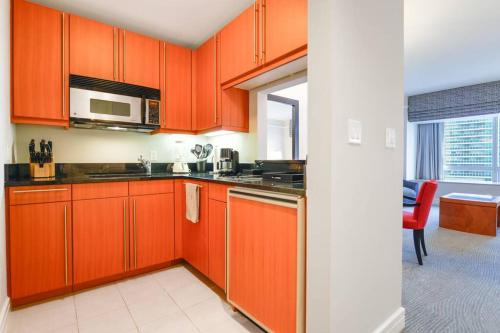 a kitchen with orange cabinets and a microwave at Live the Miami Experience in an Exclusive Condo 4S in Miami