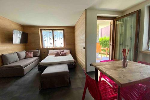 ein Wohnzimmer mit einem Sofa und einem Tisch in der Unterkunft La petite maison d'Erika in Aosta