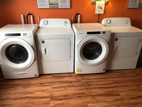 three washing machines and a washer and dryer in a room at Reliance Inn in Wausau