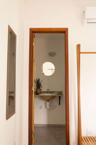 a bathroom with a sink and a mirror at Hospedaria Oitis in Búzios
