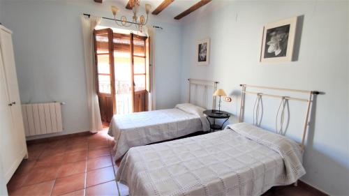 CarcelénにあるCasa Rural Carcelenのベッドルーム1室(ベッド2台、窓付)