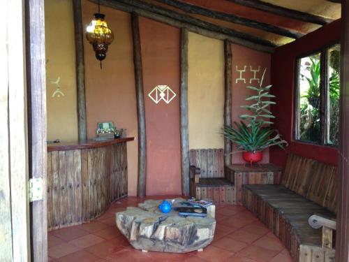 a porch of a house with a bench and a plant at Akawanka Lodge in San Agustín