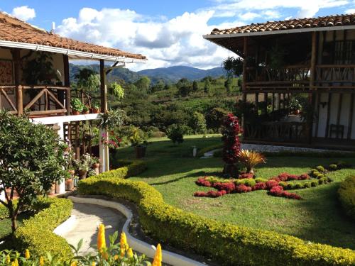 a garden in front of a house with flowers at Akawanka Lodge in San Agustín